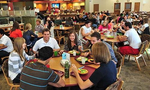 large groups of male 和 female students having lunch in the 校园中心's Main Dining Hall